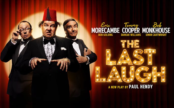 Three comedians in tuxedos on stage for "The Last Laugh" play.