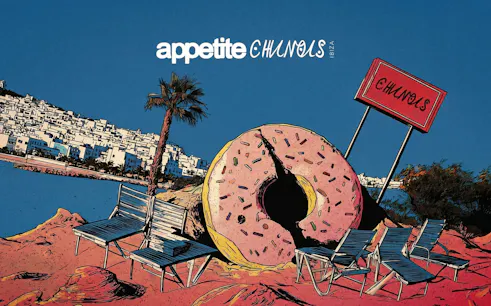 Chairs and giant donut sculpture on Ibiza beach near Chinois restaurant.