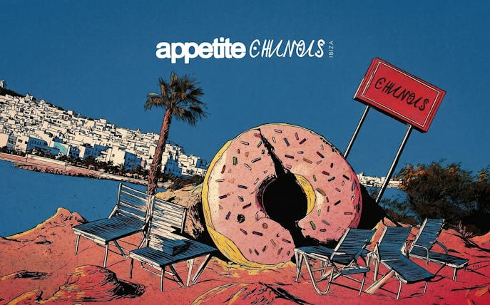 Chairs and giant donut sculpture on Ibiza beach near Chinois restaurant.
