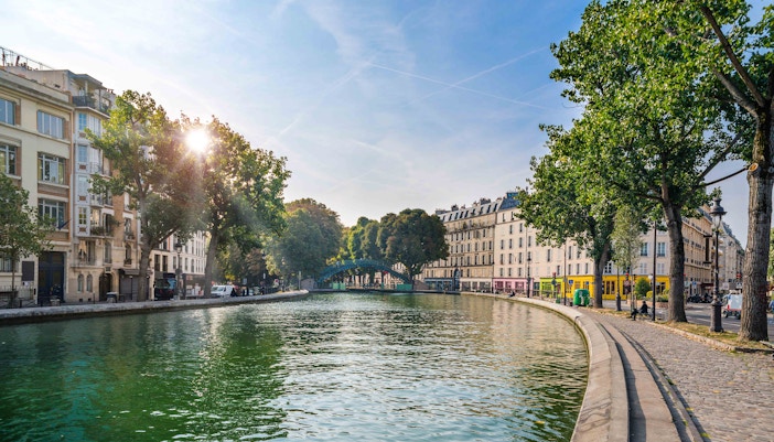 Canal Saint Martin with boats and tree-lined banks in Paris, France.