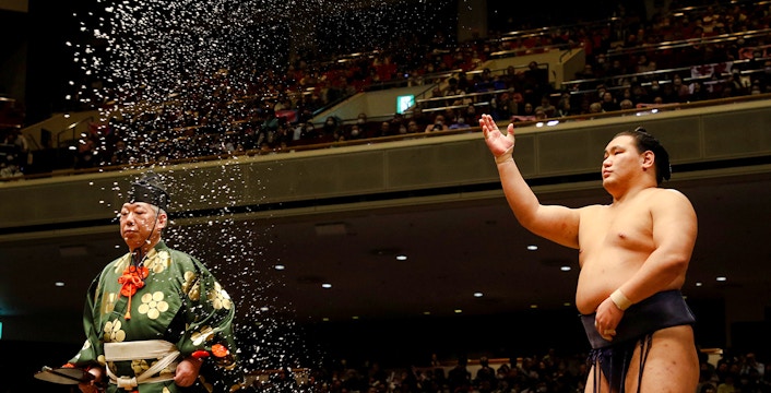 Sumo wrestler performing ritual at Fukuoka Sumo Tournament.