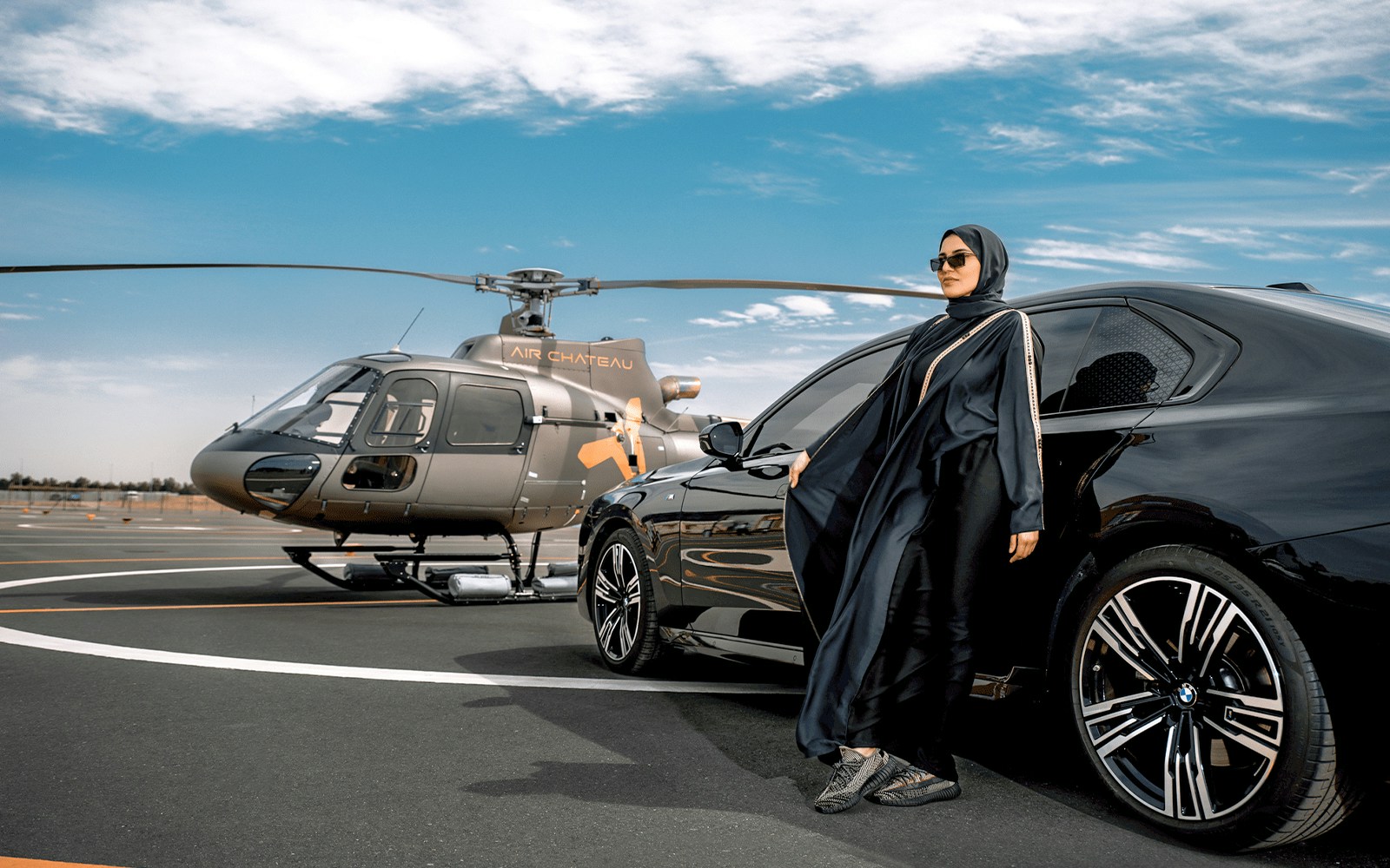 Helicopter and luxury car on tarmac for tour with return transfer.