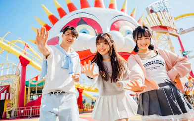 Friends posing in front of a colorful clown face at Ocean Park.