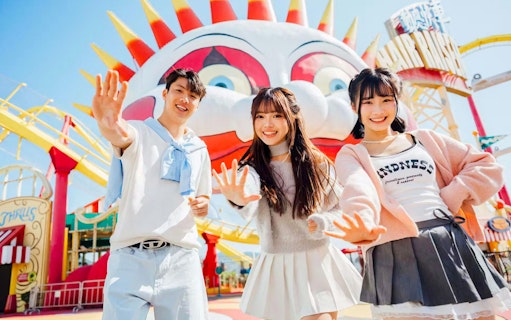 Friends posing in front of a colorful clown face at Ocean Park.
