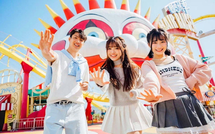Friends posing in front of a colorful clown face at Ocean Park.