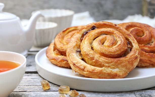 Pastries served with tea on HafenCity food tour in Hamburg.