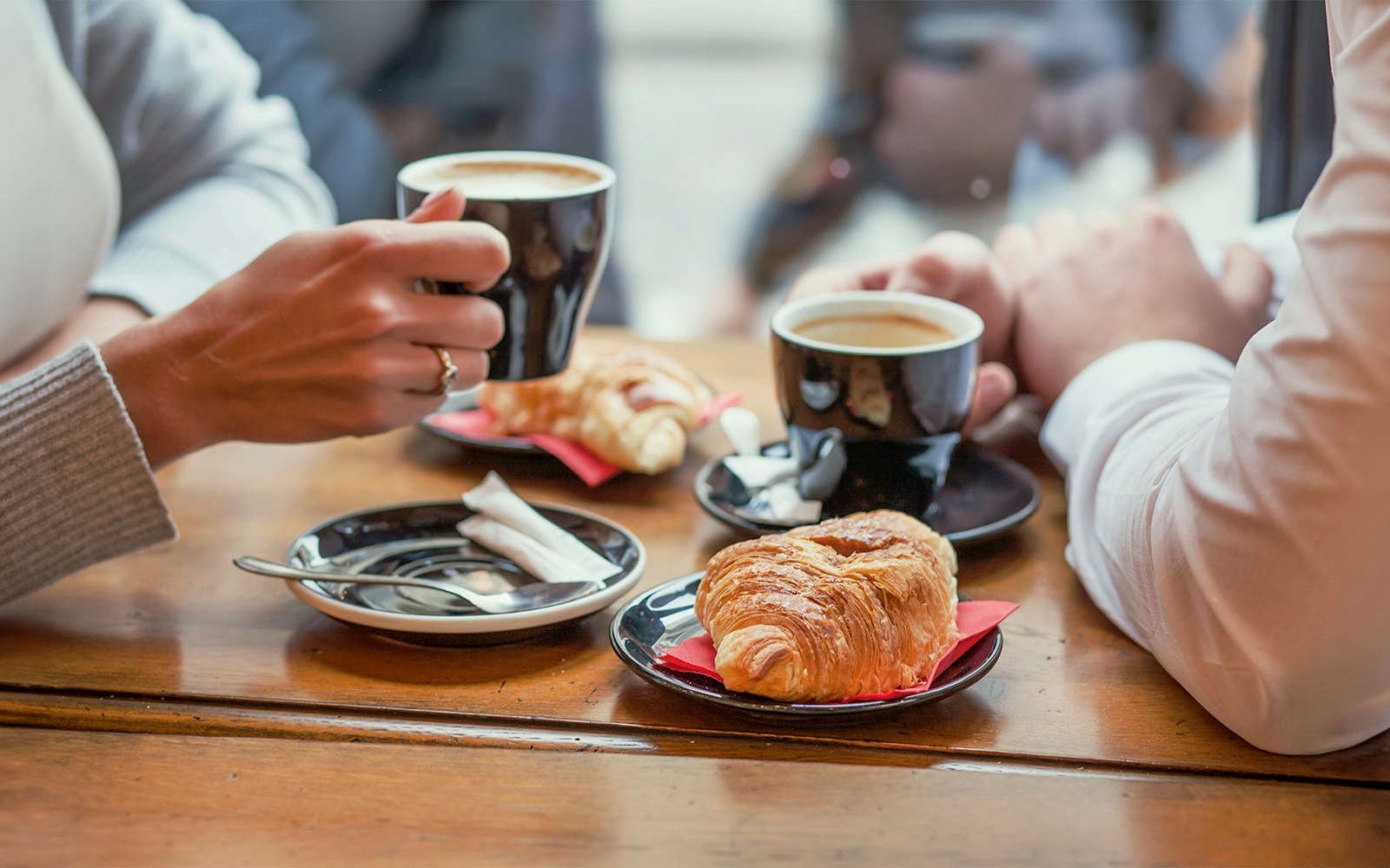 Seine River cruise in Paris with passengers enjoying a French breakfast on a sunny morning.