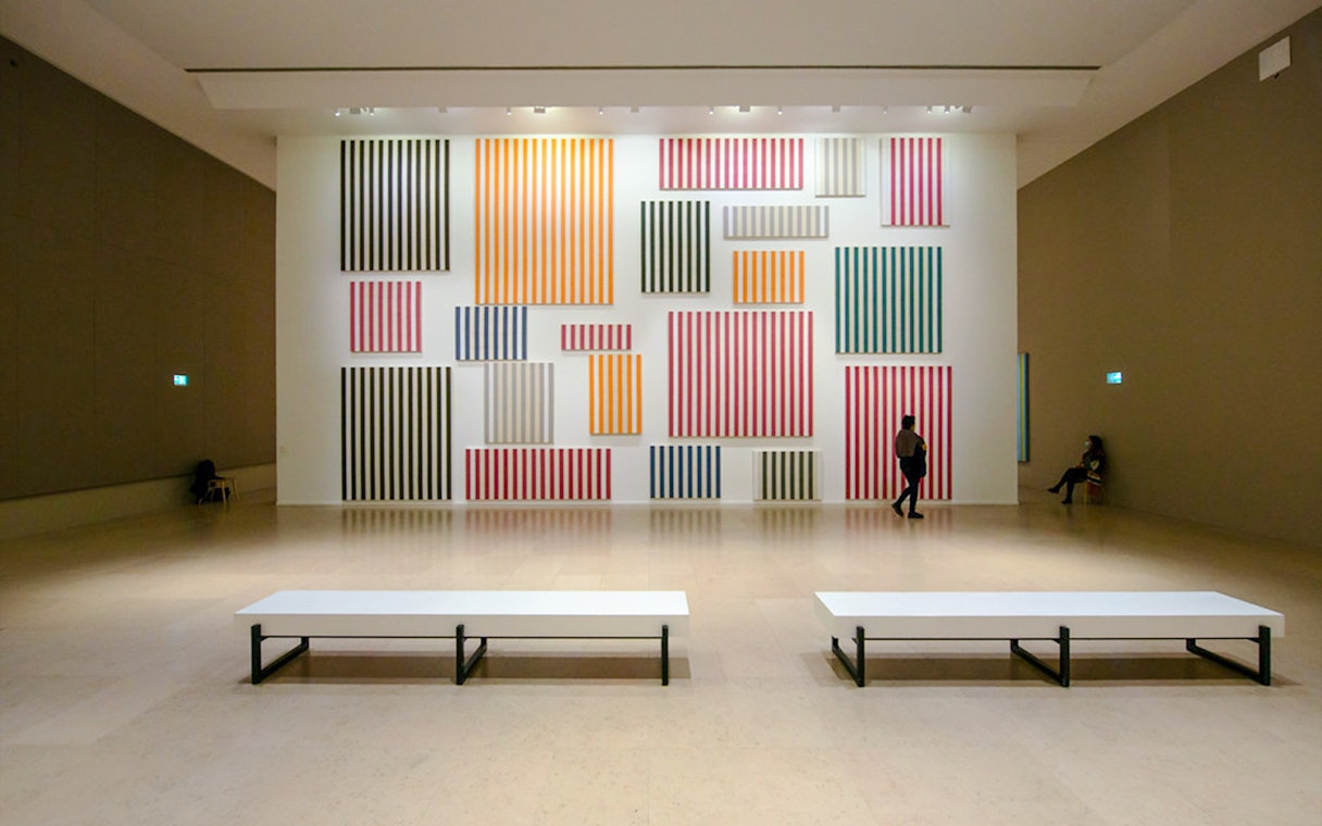 Striped artwork display inside Museum of Modern Art exhibit hall.
