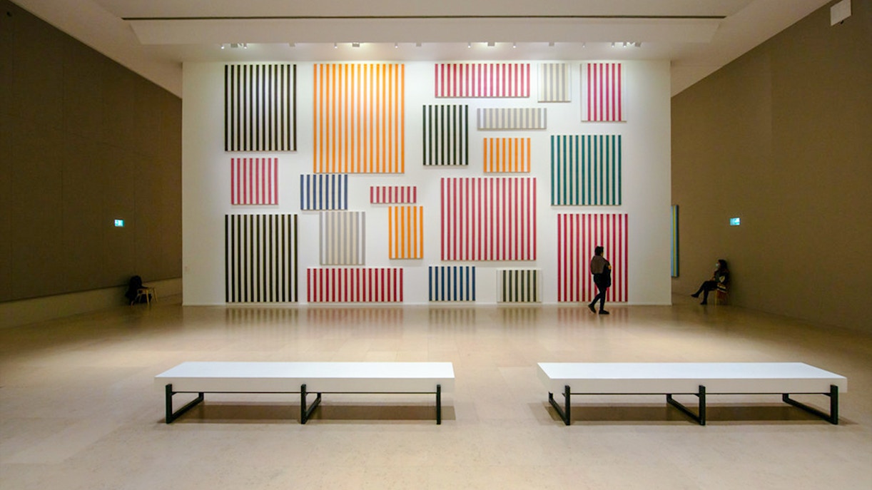 Striped artwork display inside Museum of Modern Art exhibit hall.