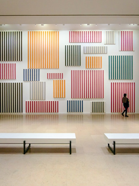 Striped artwork display inside Museum of Modern Art exhibit hall.