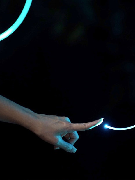 Hand touching glowing light trail in Dream Forest Langkawi.