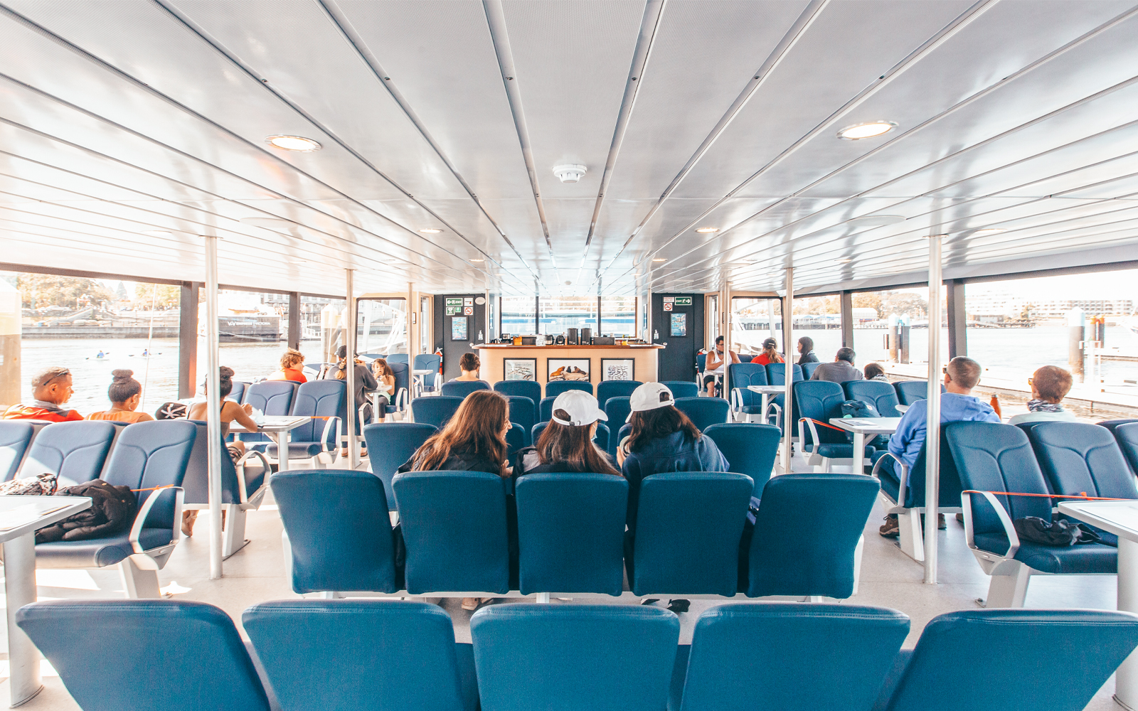 Interior seating area of the Salish Sea Eclipse catamaran with passengers enjoying the view.