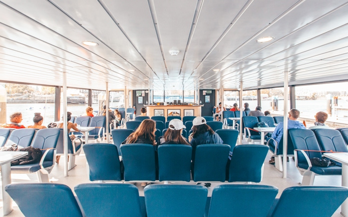 Interior seating area of the Salish Sea Eclipse catamaran with passengers enjoying the view.