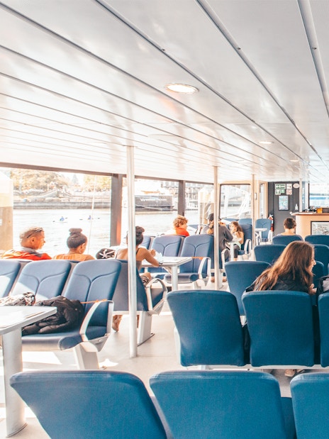 Interior seating area of the Salish Sea Eclipse catamaran with passengers enjoying the view.
