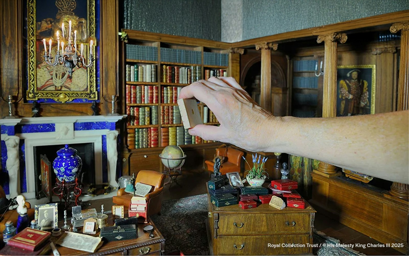 Queen Mary's Dolls House library with miniature books and furniture.