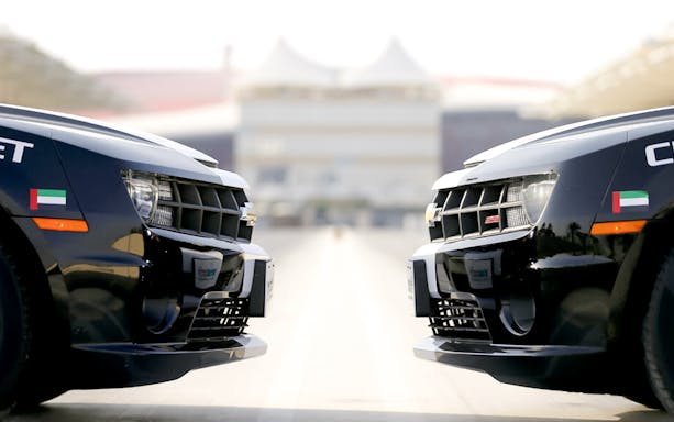 Chevrolet Camaro SS cars facing each other at Yas Marina Circuit.