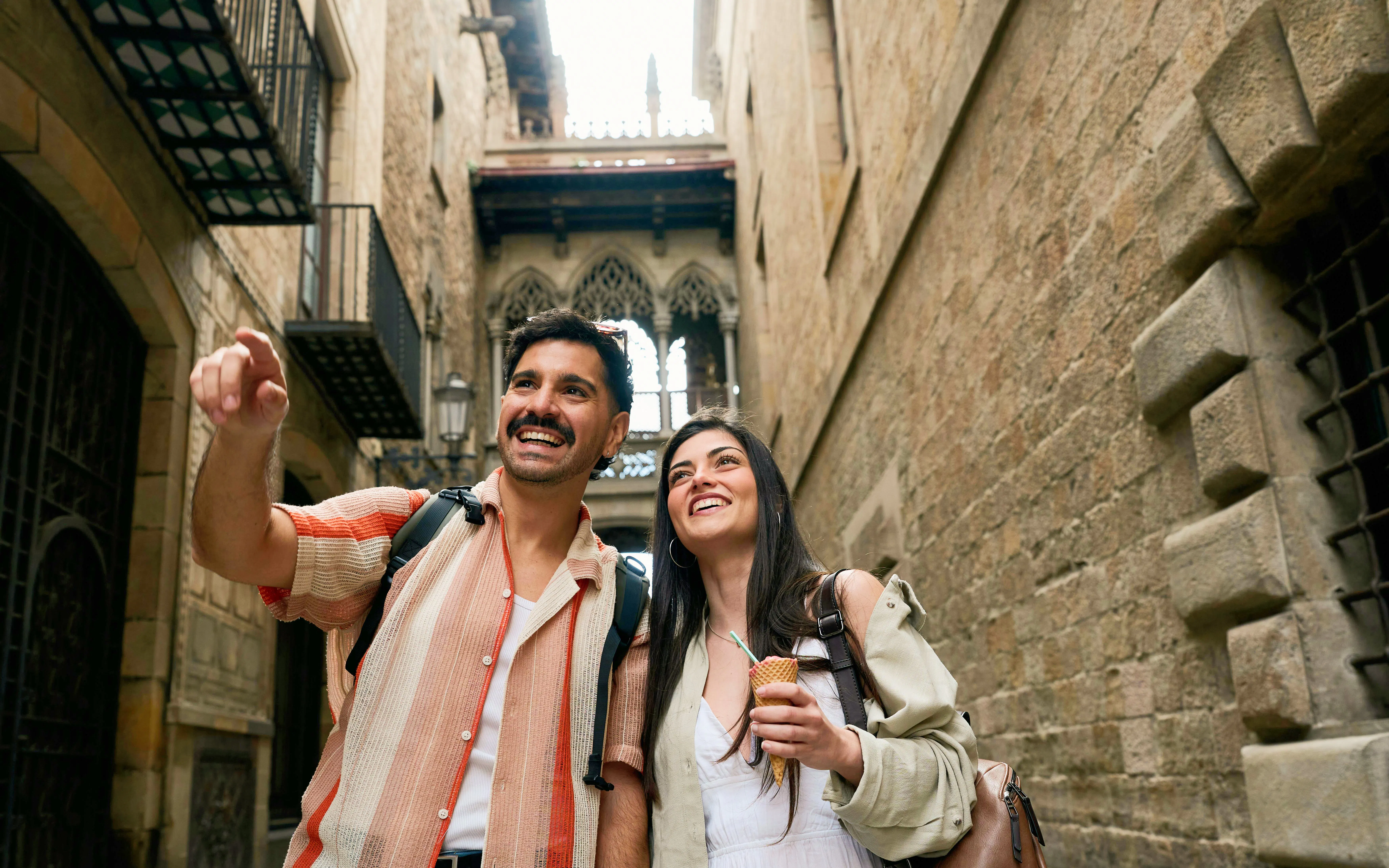 Tourists enjoying a walk in the historic Barri Gòtic street, Barcelona.