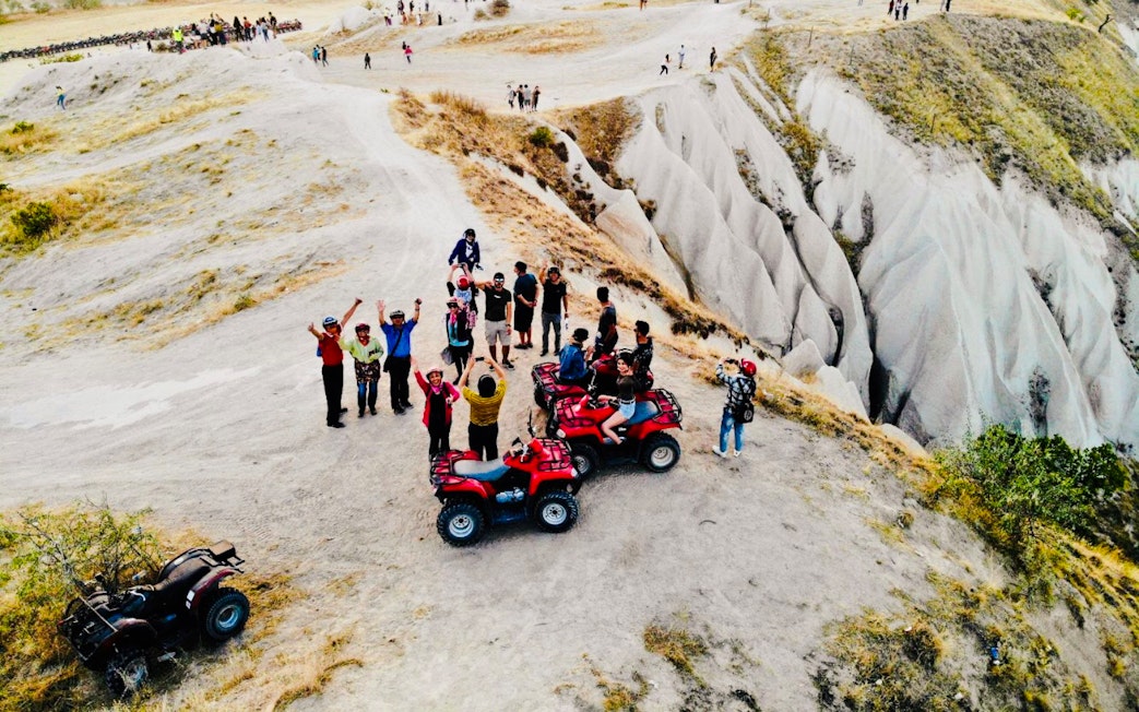 Guests riding ATVs on a rocky trail in Cappadocia, Turkey.