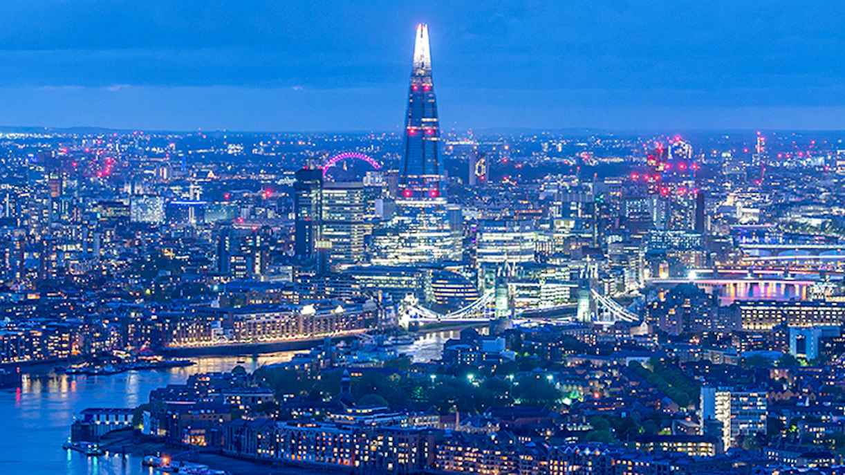London skyline at night featuring The Shard and River Thames.