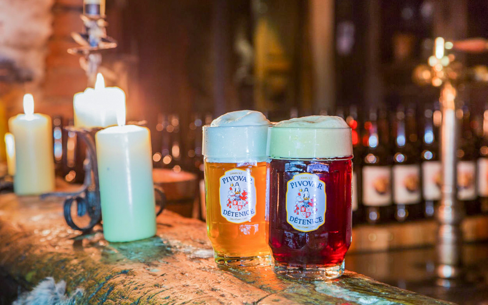 Light and dark beer mugs on a wooden table at Medieval Dinner Show.