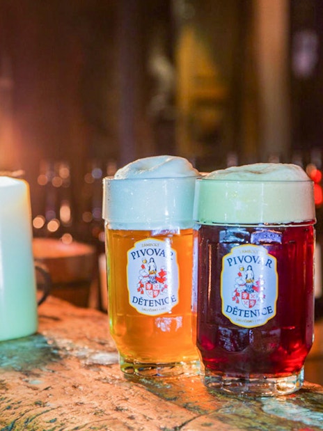 Light and dark beer mugs on a wooden table at Medieval Dinner Show.