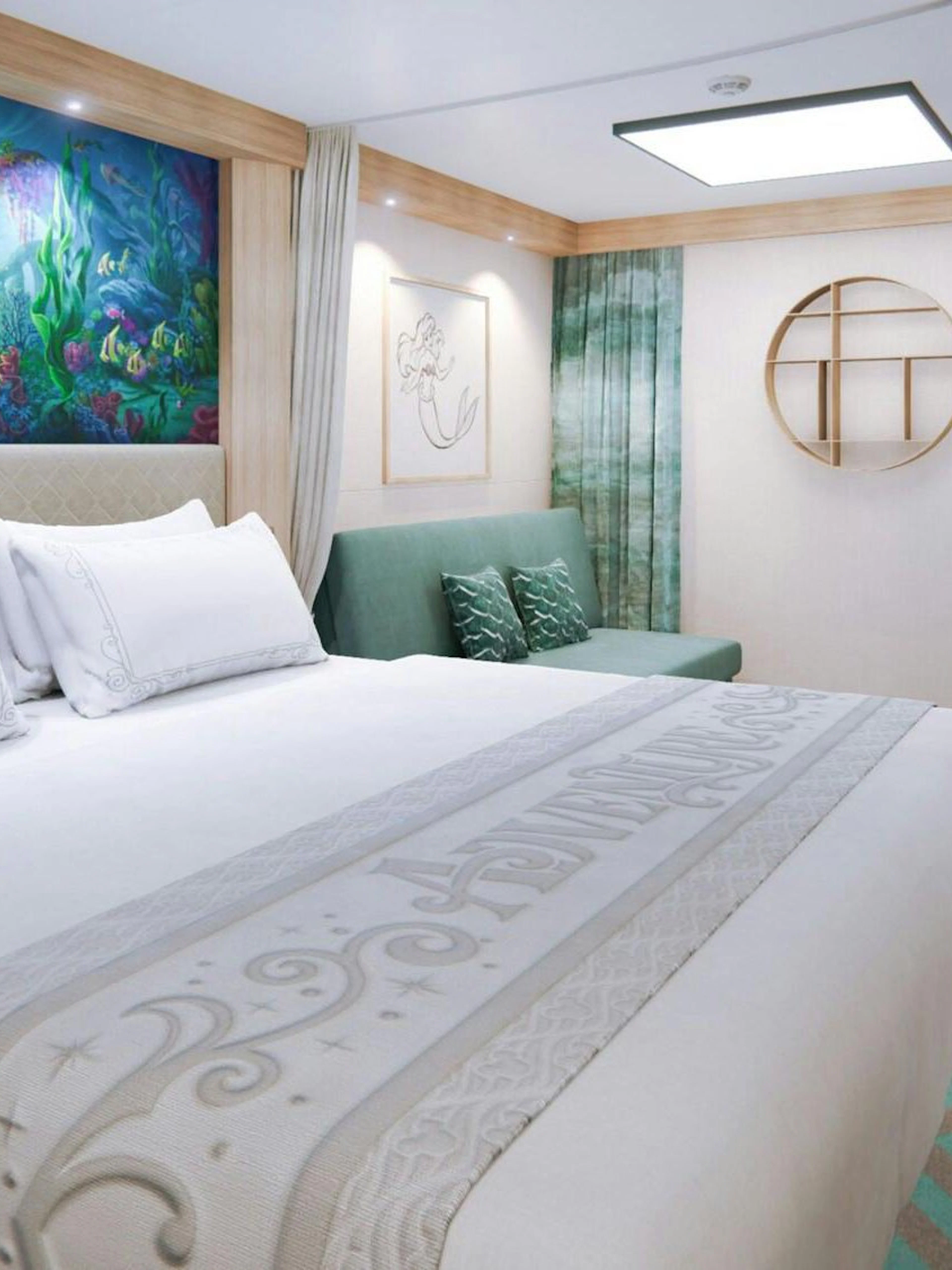 Deluxe cruise cabin with ocean-themed decor and comfortable bedding.