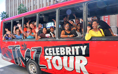 Tourists waving from TMZ Celebrity Tour bus in Hollywood.