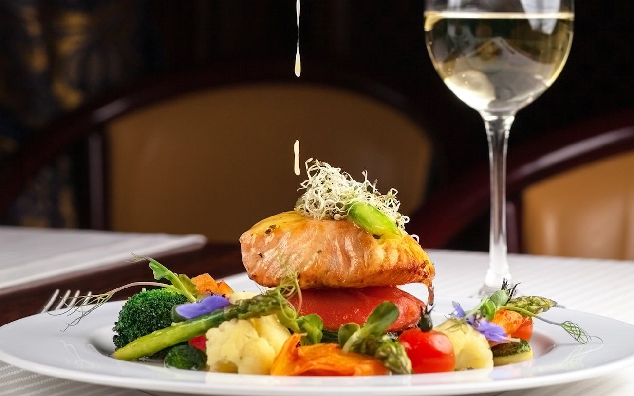 Salmon dish with vegetables and sauce at Reichstag restaurant, Berlin.