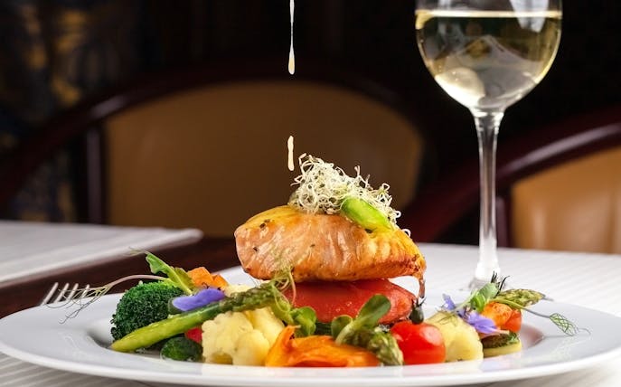 Salmon dish with vegetables and sauce at Reichstag restaurant, Berlin.