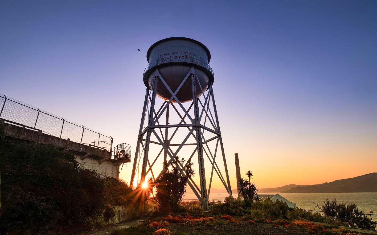 Water tower at sunset on Alcatraz Island during night tour with ferry ride.