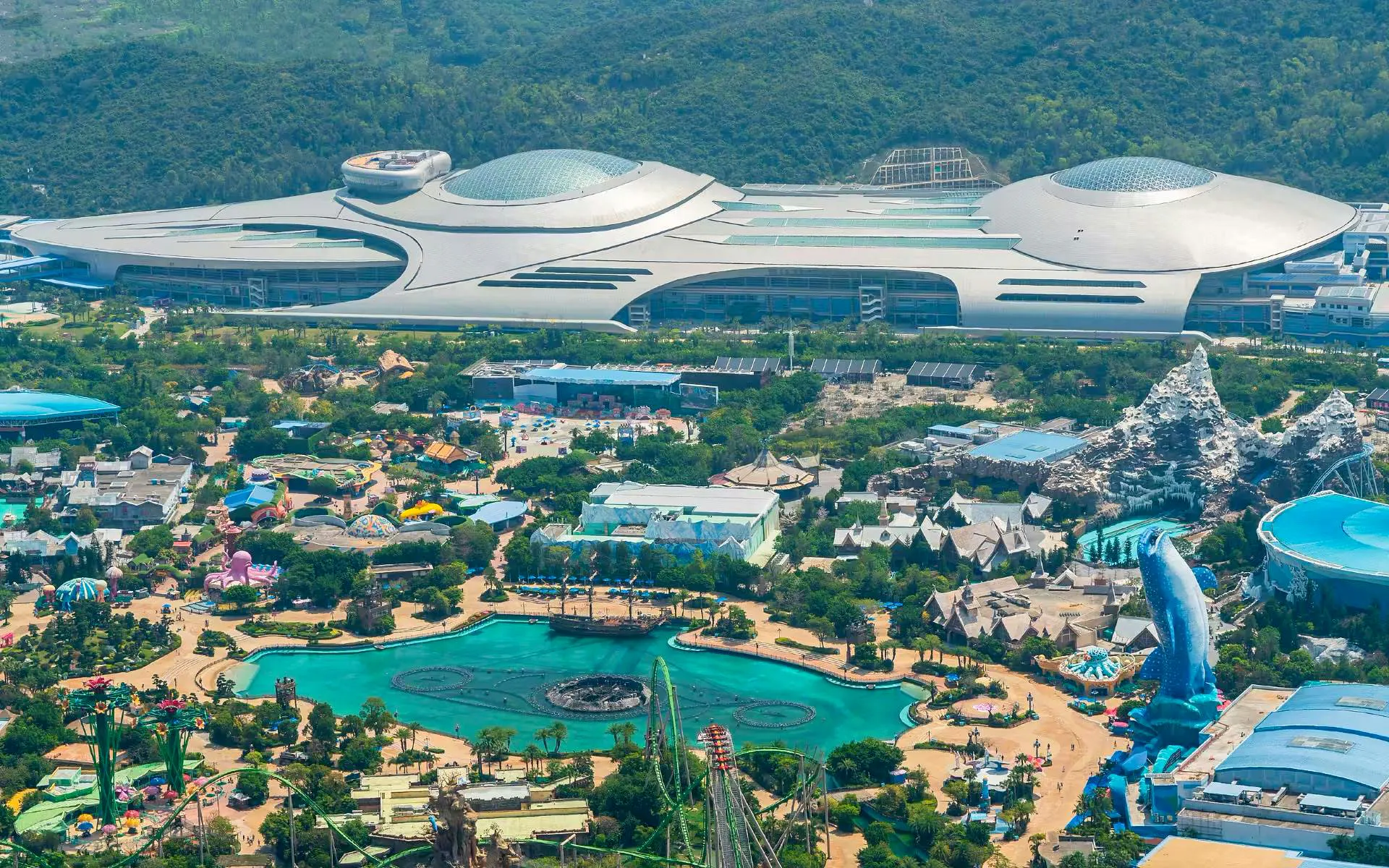 Aerial view of Chimelong Spaceship indoor theme park in Zhuhai, China, featuring futuristic architecture and attractions.