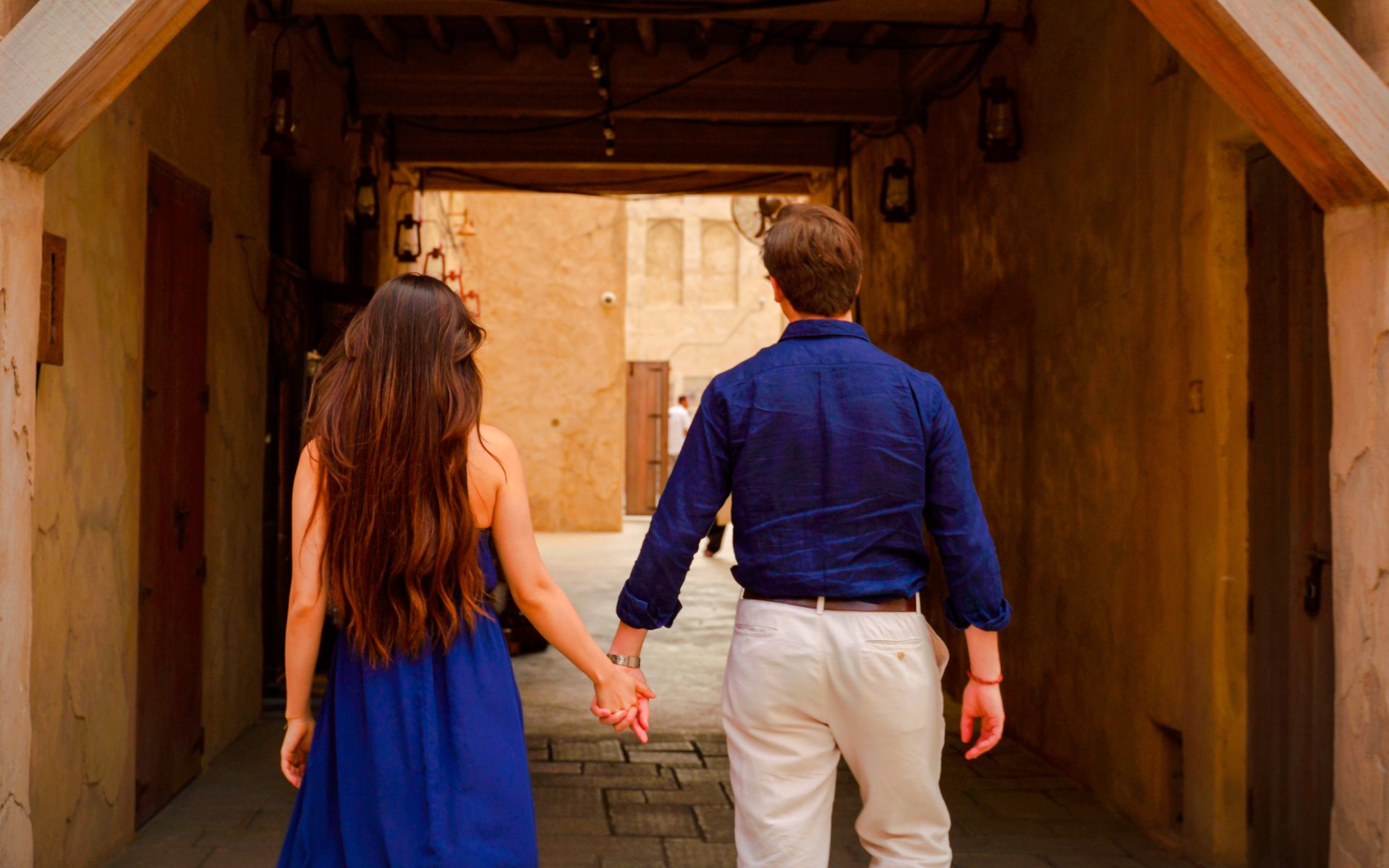 Couple walking hand in hand inside Al Khayma, Dubai.