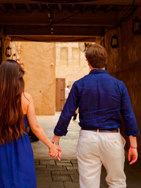 Couple walking hand in hand inside Al Khayma, Dubai.