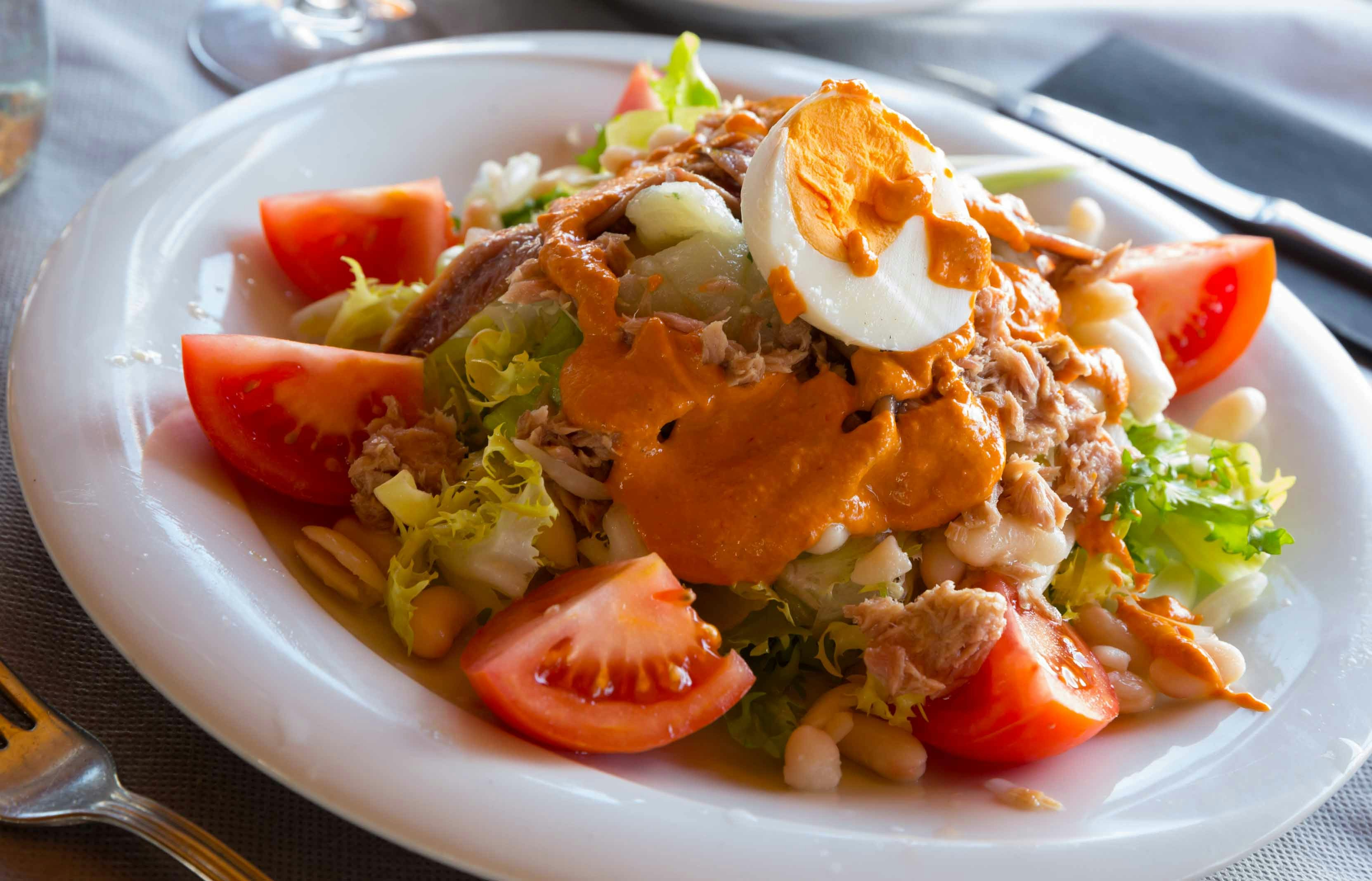 Catalan salad with fresh vegetables and olives in Barcelona, Spain.
