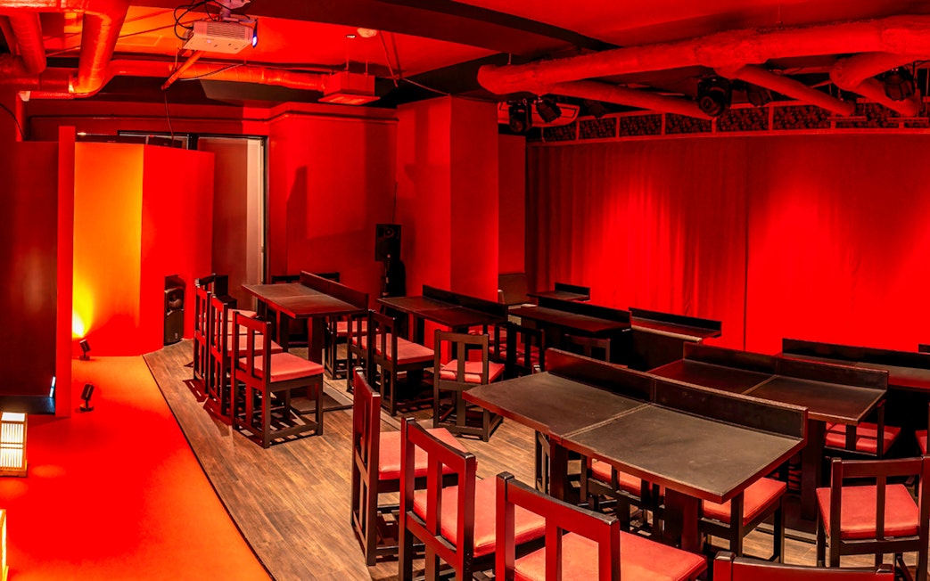 Japanese cabaret theatre interior with red decor and seating in Tokyo.