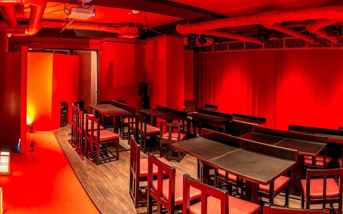 Japanese cabaret theatre interior with red decor and seating in Tokyo.