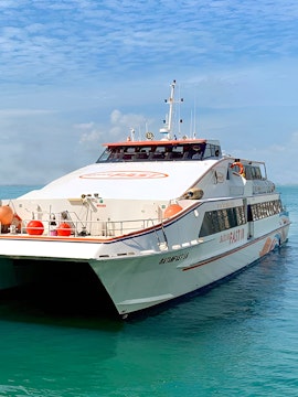Ferry from Singapore to Batam on clear blue water.