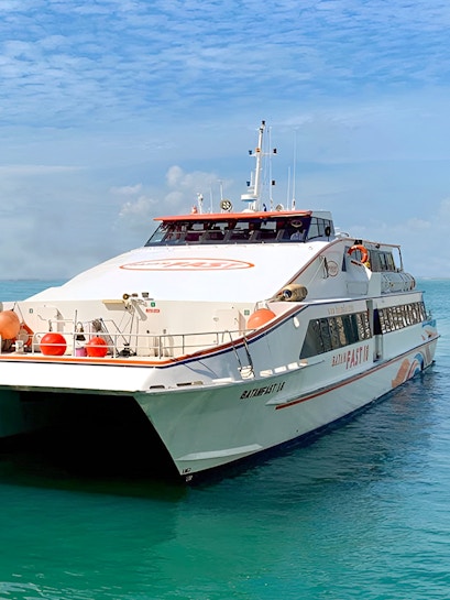 Ferry from Singapore to Batam on clear blue water.