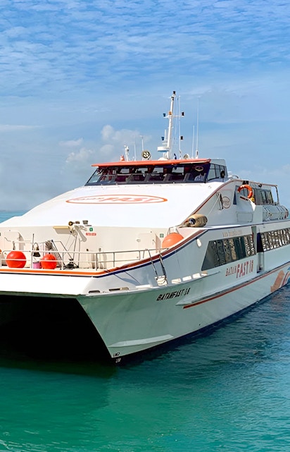 Ferry from Singapore to Batam on clear blue water.