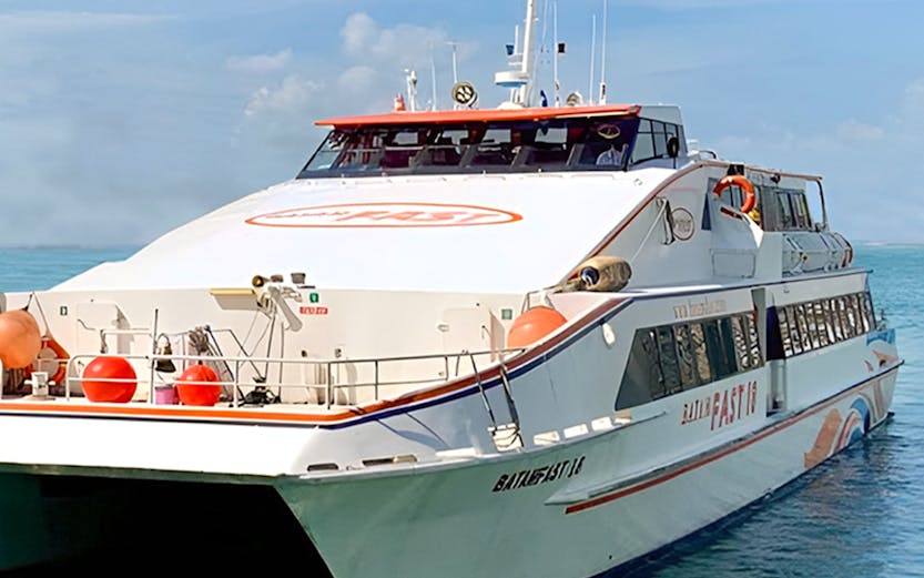 Ferry from Singapore to Batam on clear blue water.