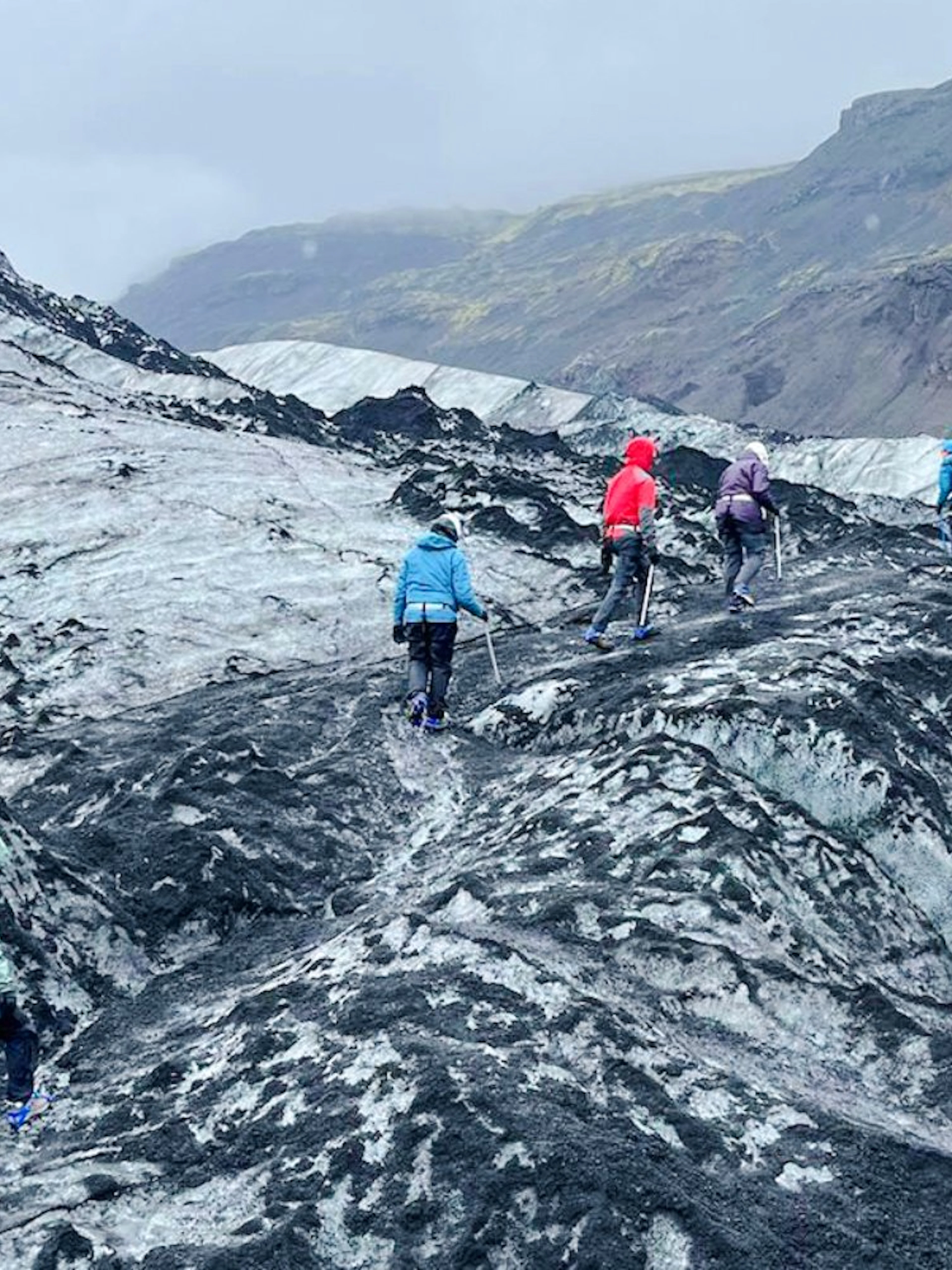 Guests hiking on Sólheimajökull Glacier in Iceland during a small group tour.