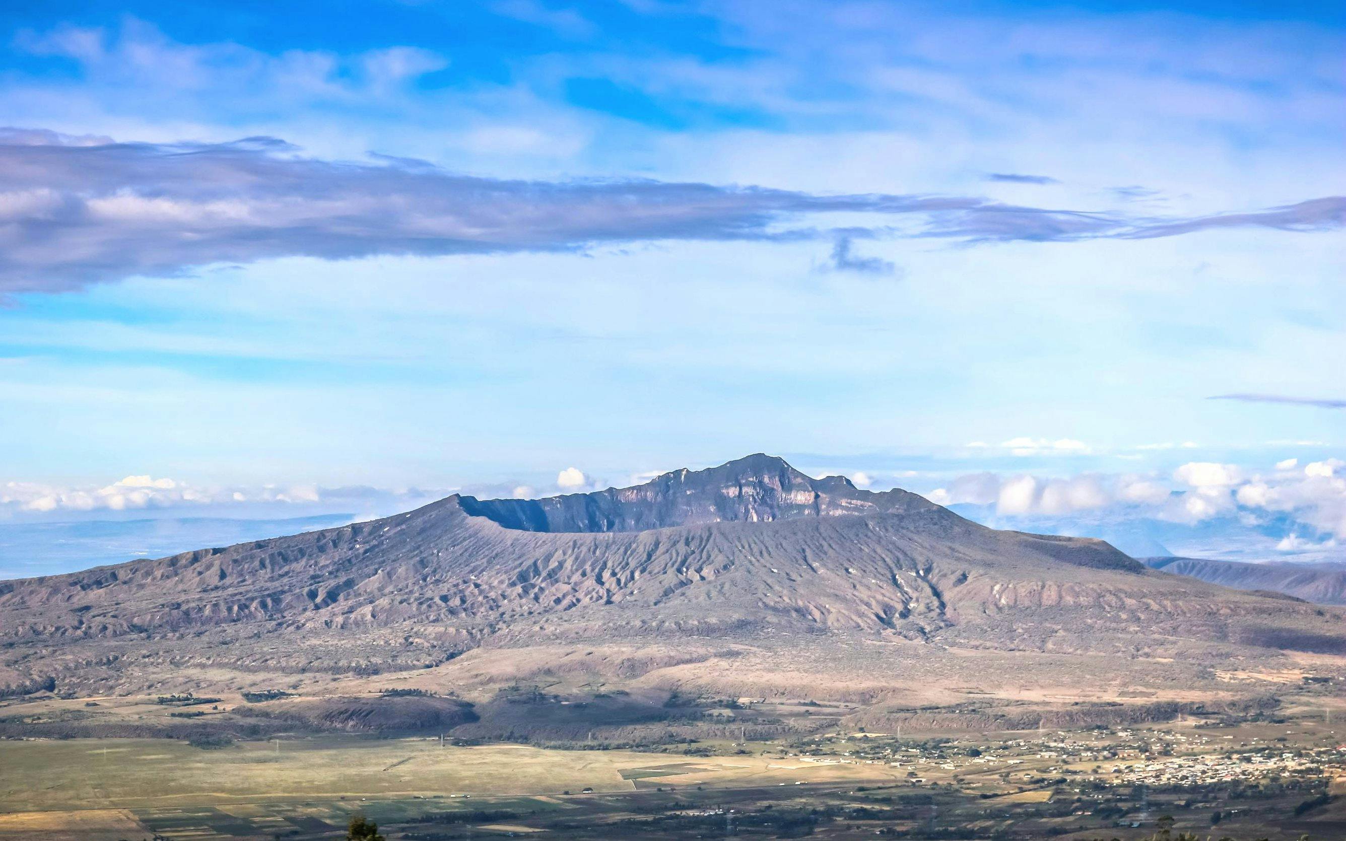 Mount Longonot crater with surrounding landscape under a clear sky near Nairobi.