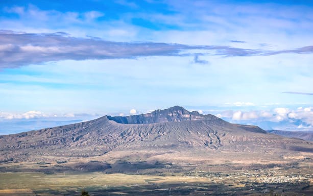 Mount Longonot crater with surrounding landscape under a clear sky near Nairobi.