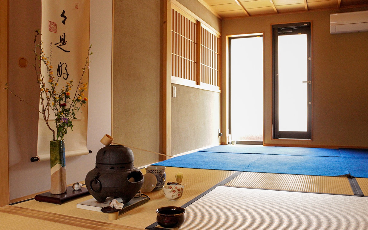 Teahouse interior with tatami mats and tea ceremony setup in Kyoto.
