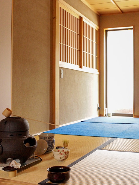 Teahouse interior with tatami mats and tea ceremony setup in Kyoto.