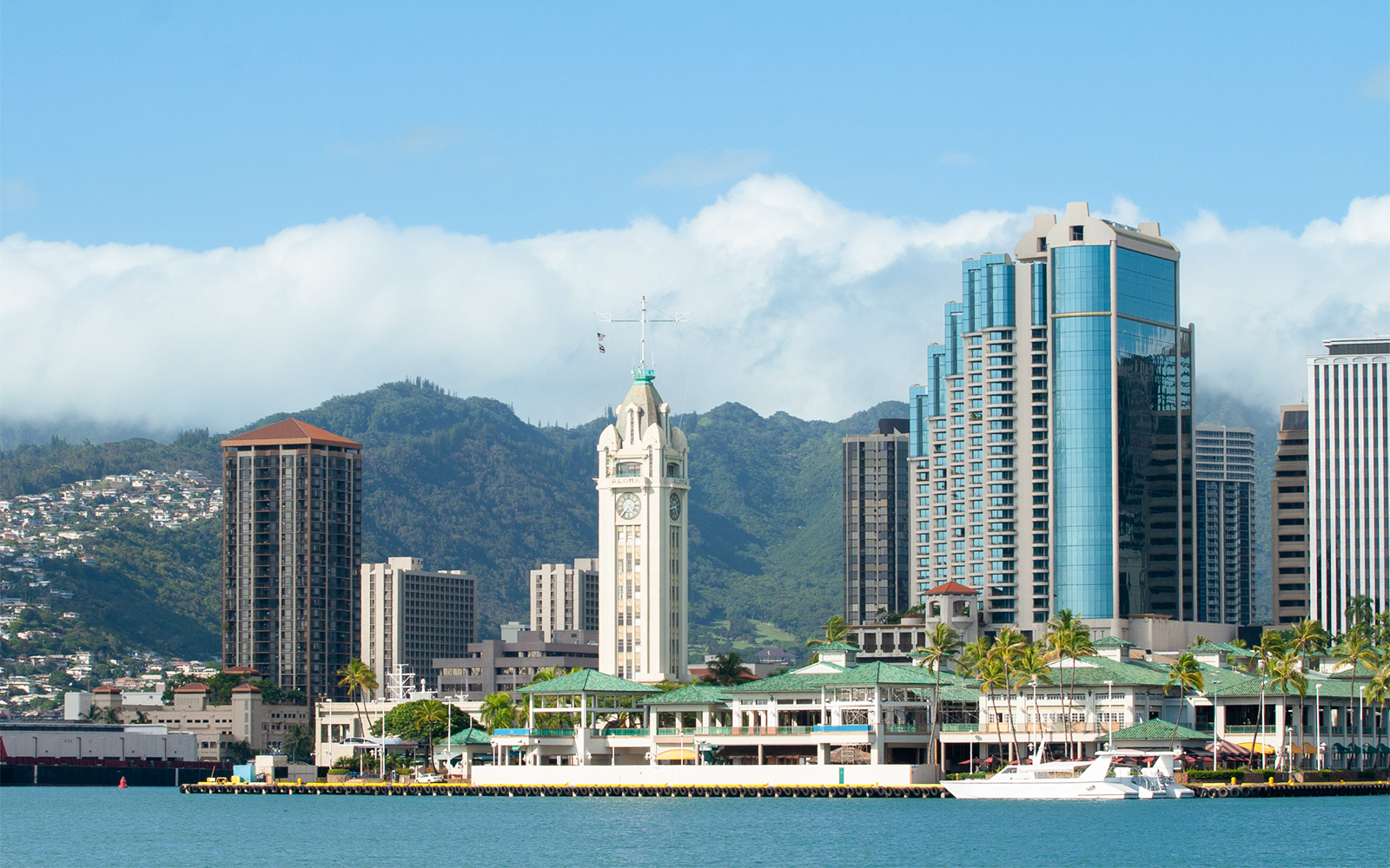 Honolulu skyline with Aloha Tower viewed from a cruise on Hawaii shore.