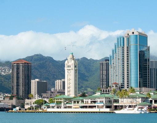 Honolulu skyline with Aloha Tower viewed from a cruise on Hawaii shore.