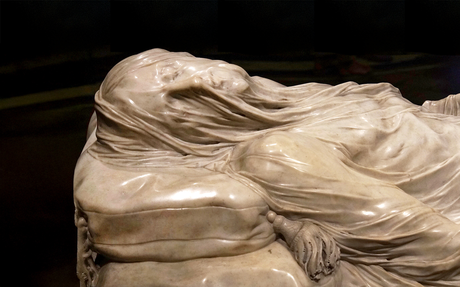 Veiled Christ sculpture in Naples' Sansevero Chapel, showcasing intricate marble craftsmanship.