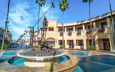 Universal Studios Hollywood entrance with iconic film-themed statues.