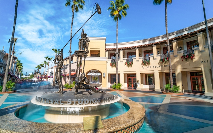 Universal Studios Hollywood entrance with iconic film-themed statues.